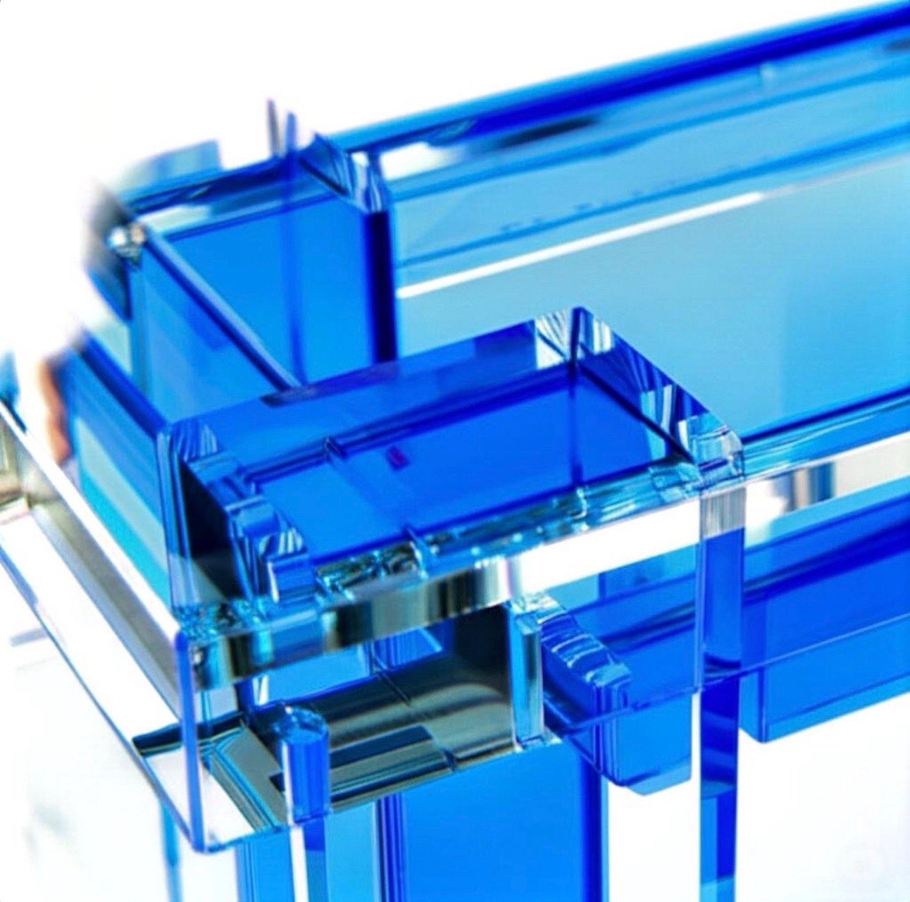 Close-up of the AquaLux modern acrylic coffee table highlighting the premium 40mm thick acrylic and vibrant blue accents for a chic look.